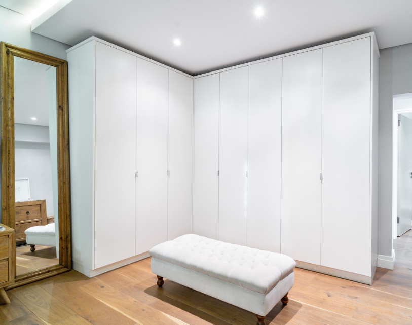 White floor-to-ceiling hinged wardrobe with full-length mirror and ottoman, Durban bedroom
