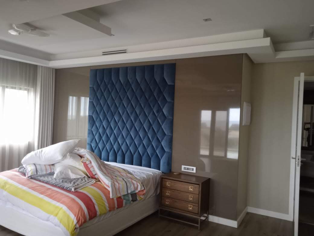 Luxury tufted headboard with curved pedestals and cream upholstery — Morningside Durban by El-Shaddai Interiors