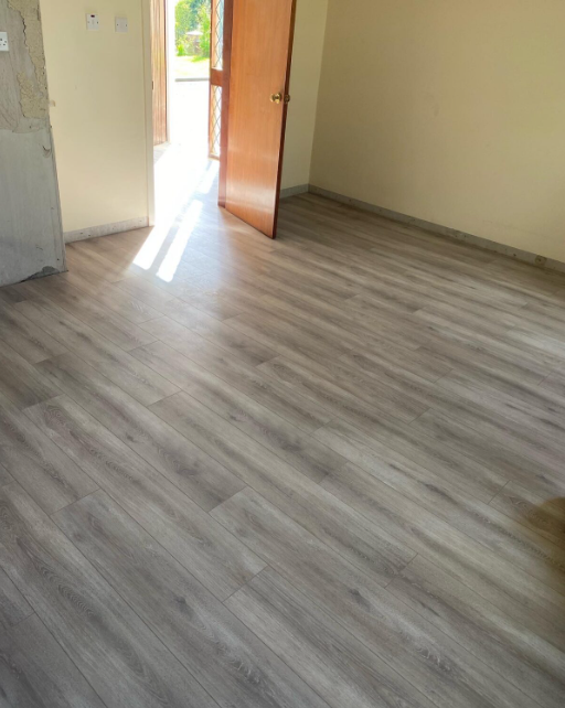 Lounge and passage laminate flooring project — Durban North by El-Shaddai Interiors