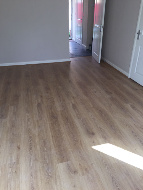 Open-plan kitchen and lounge laminate flooring — Morningside Durban by El-Shaddai Interiors