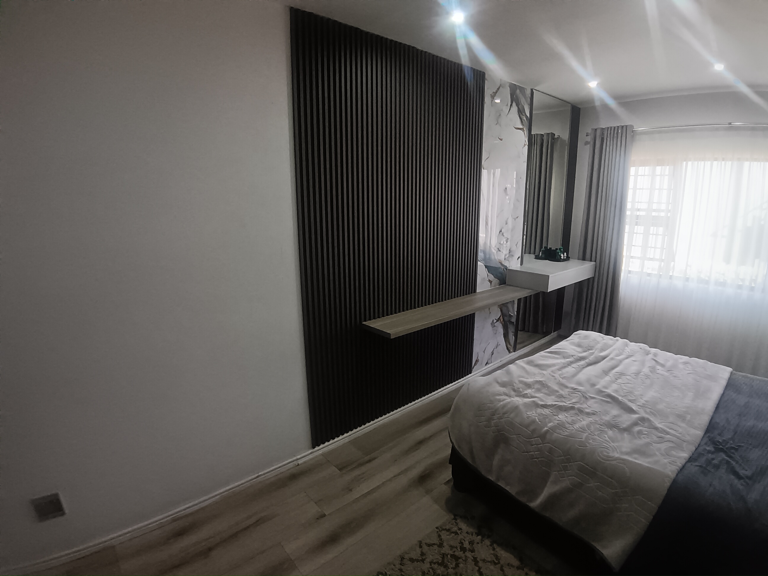 Bedroom Feature Wall in Musgrave - Slats, marble sheeting, mirror and LED lighting