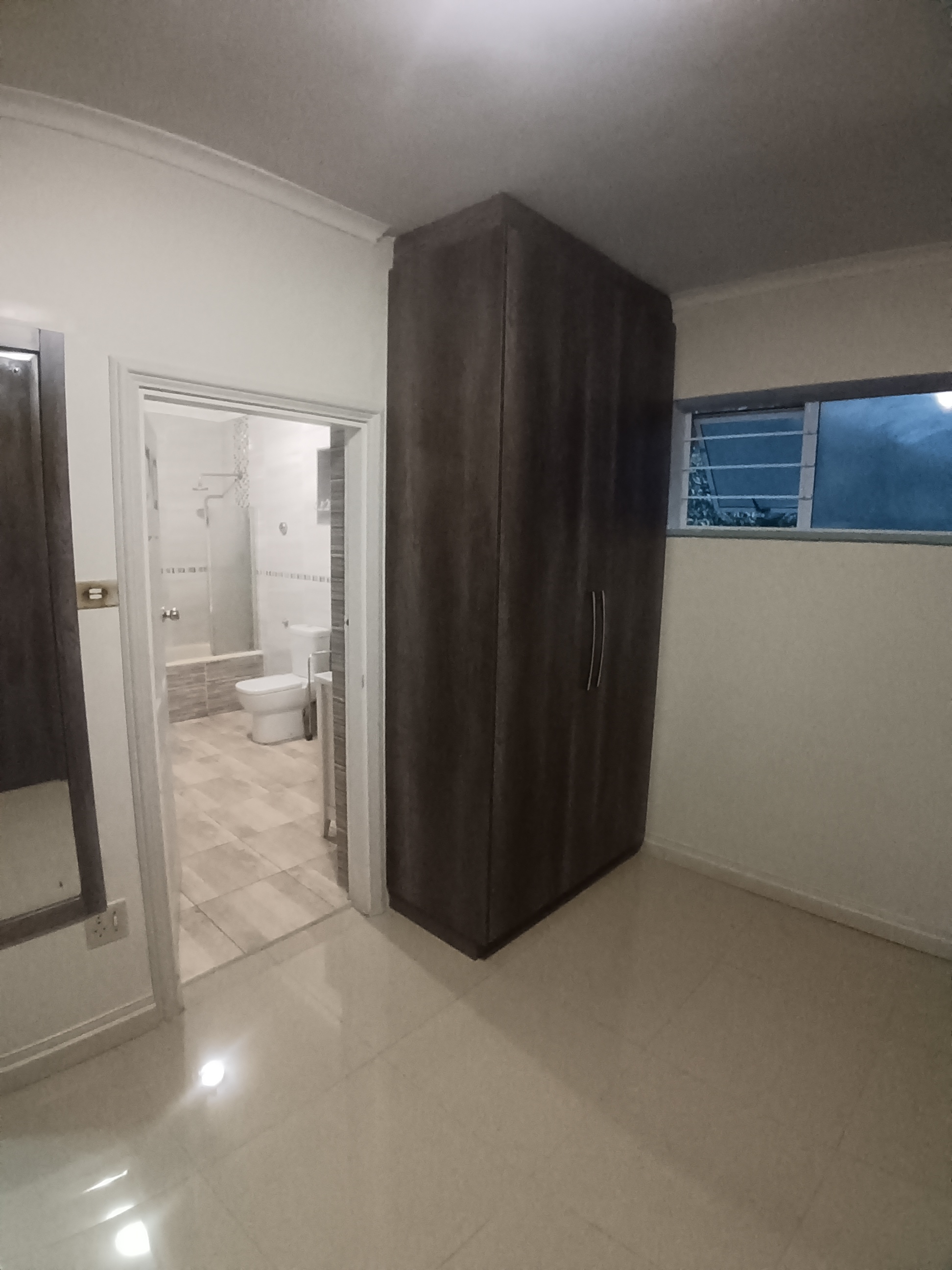 Walk-In Closet in Musgrave - Custom cupboards in Monument Oak with full ceiling and paint work