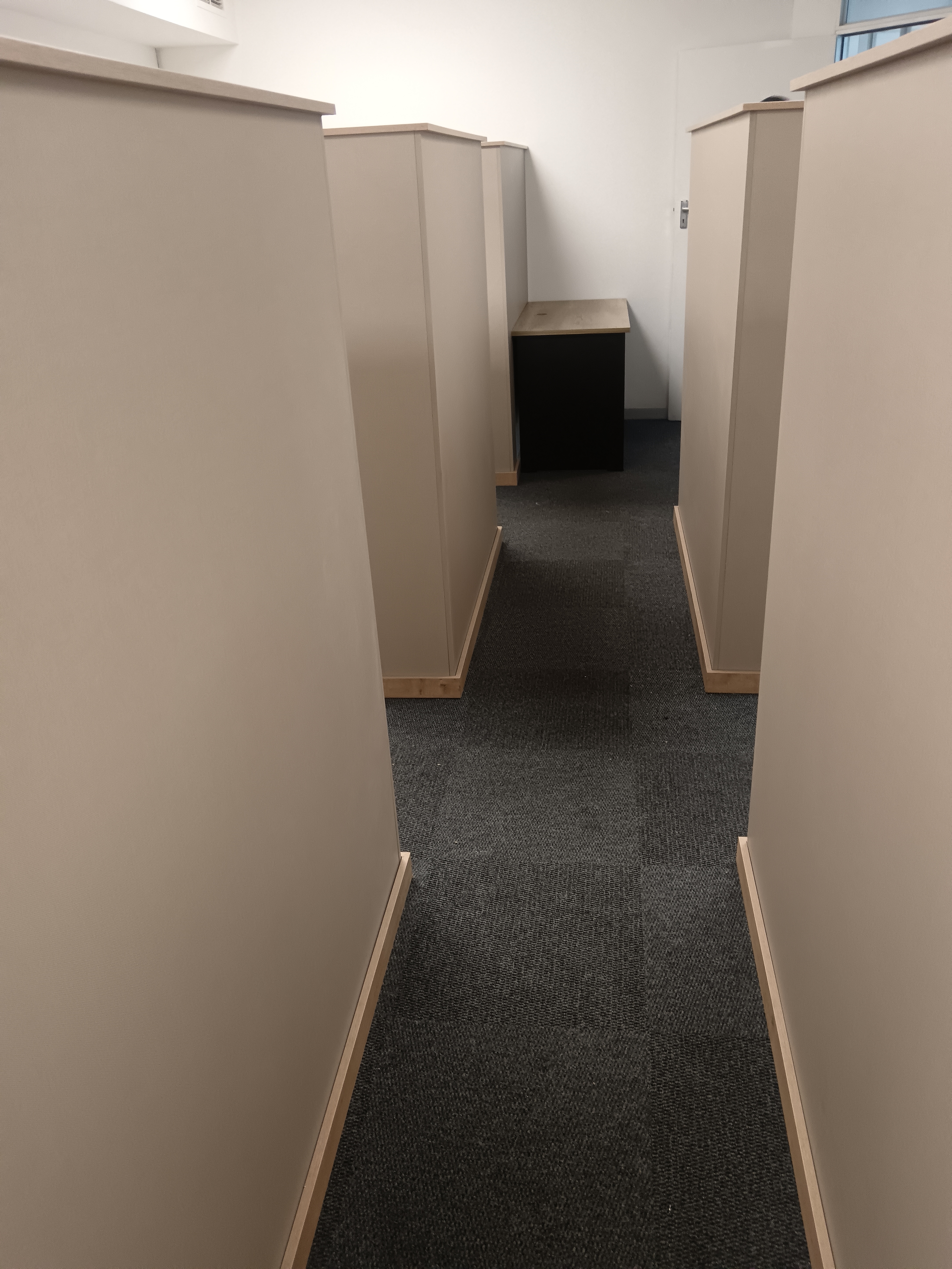 Corner partition installation with U-tracks visible