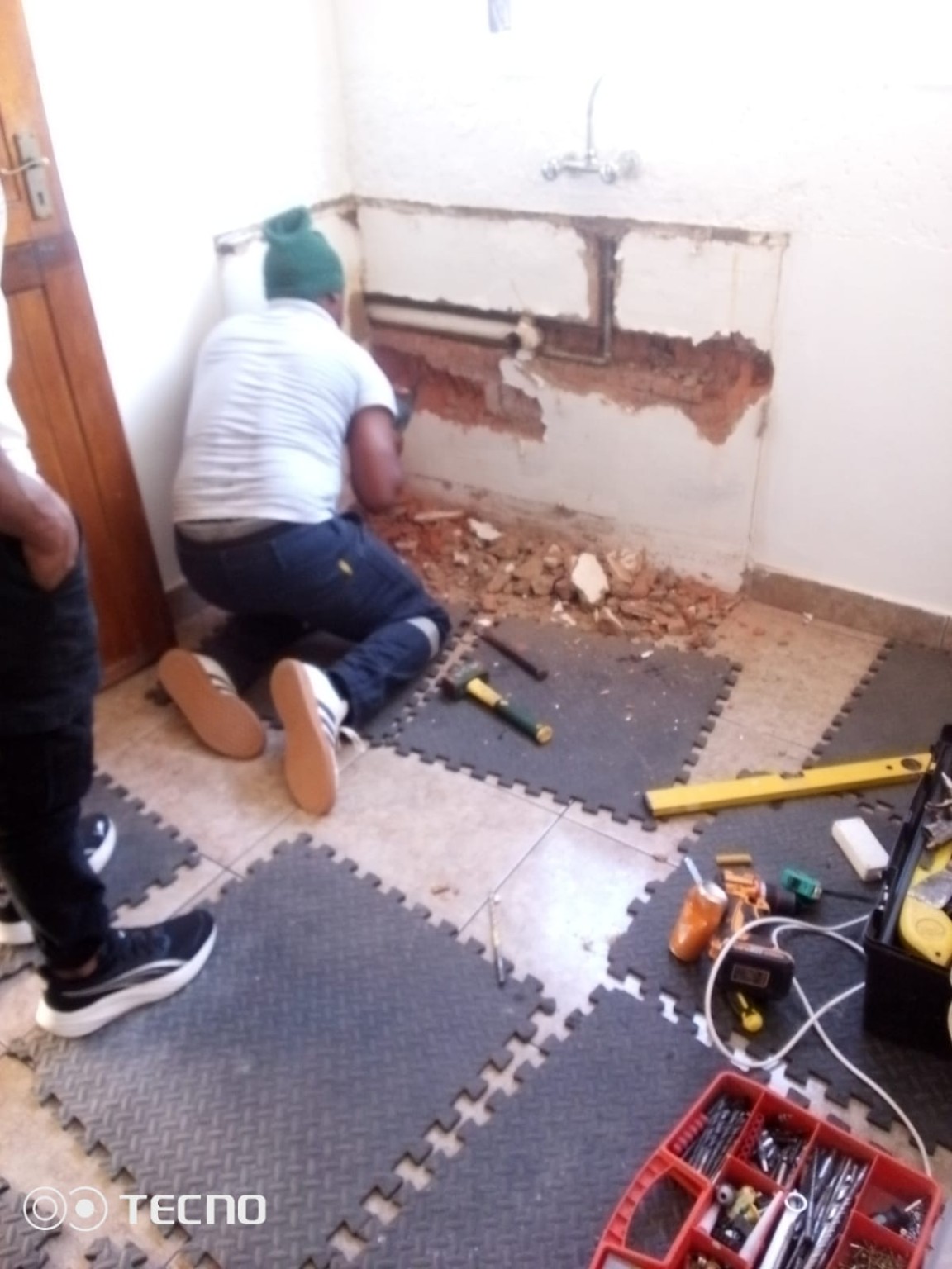 Chasing wall for plumbing before cupboard install - Yvonne's kitchen Phoenix